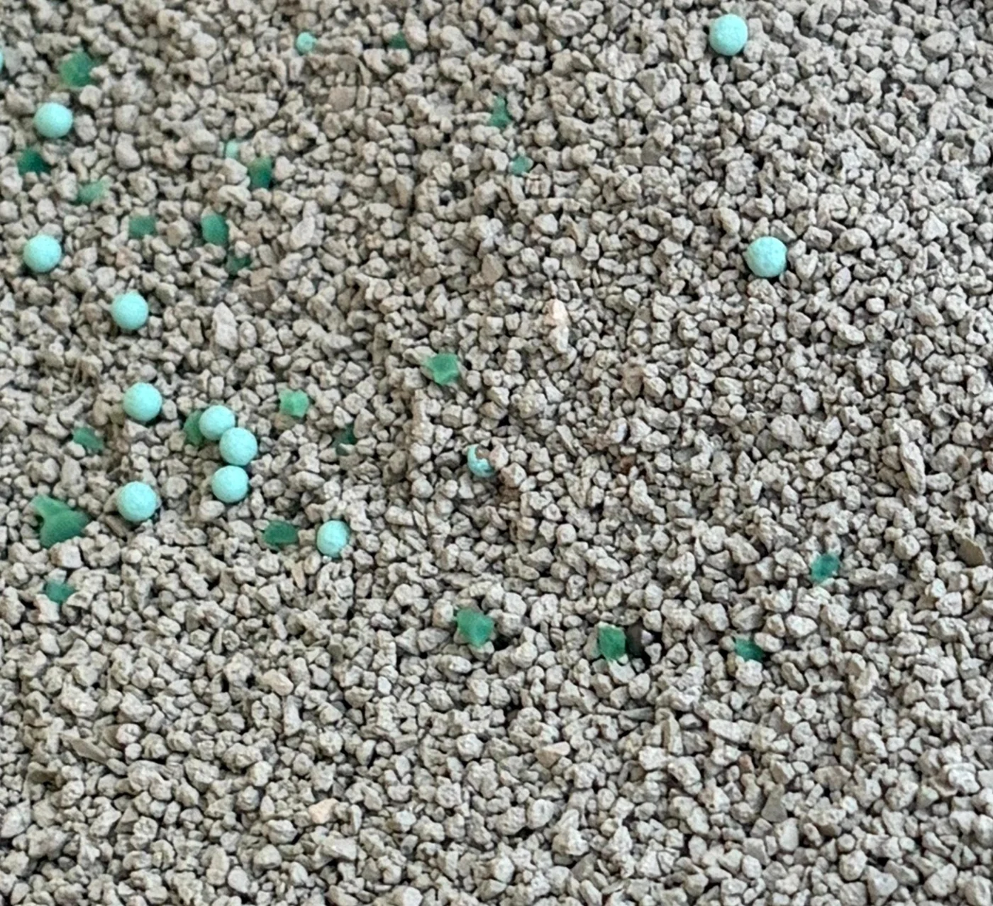 Close-up of LINGSHUAI GreenGuard granules with green and blue particles