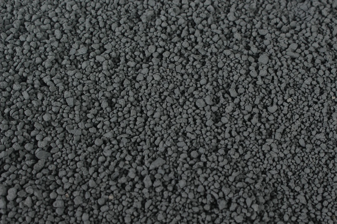 Close-up of dark irregular LINGSHUAI Crushed-type Carbon bentonite granules